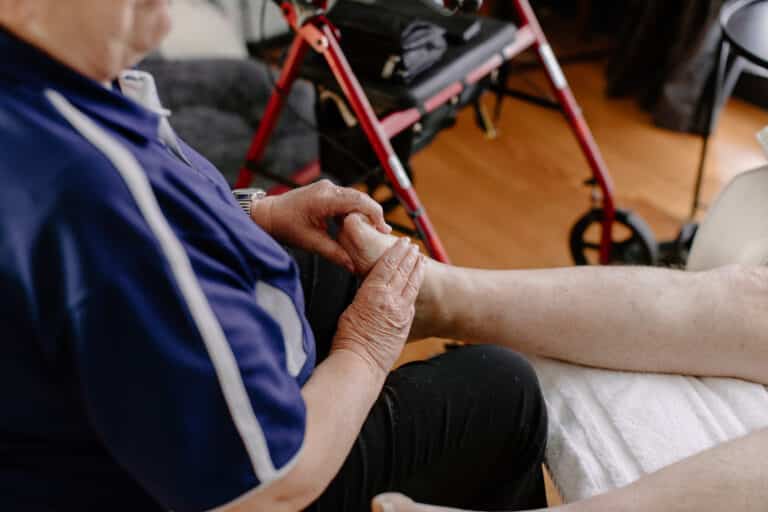 Mobile massage therapist performing a massage in house